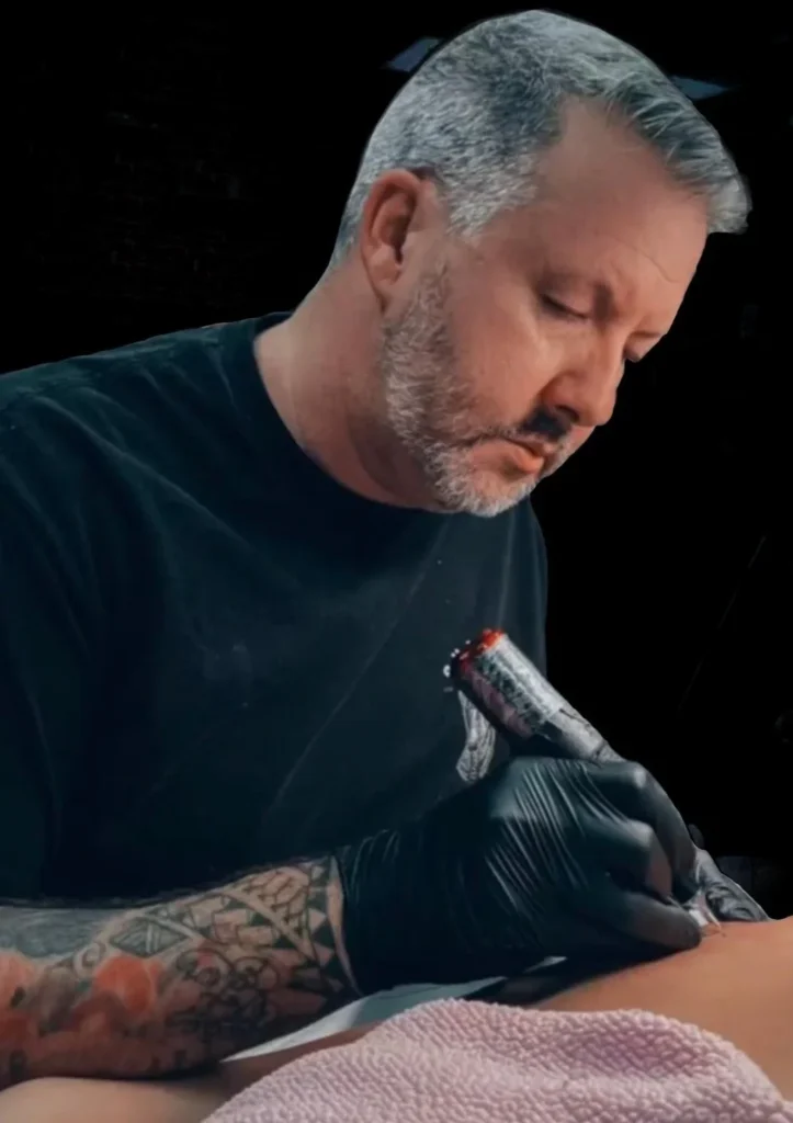 Neto tattoo artist creating custom designs at Iron Glory Tattoo Boca Raton Florida